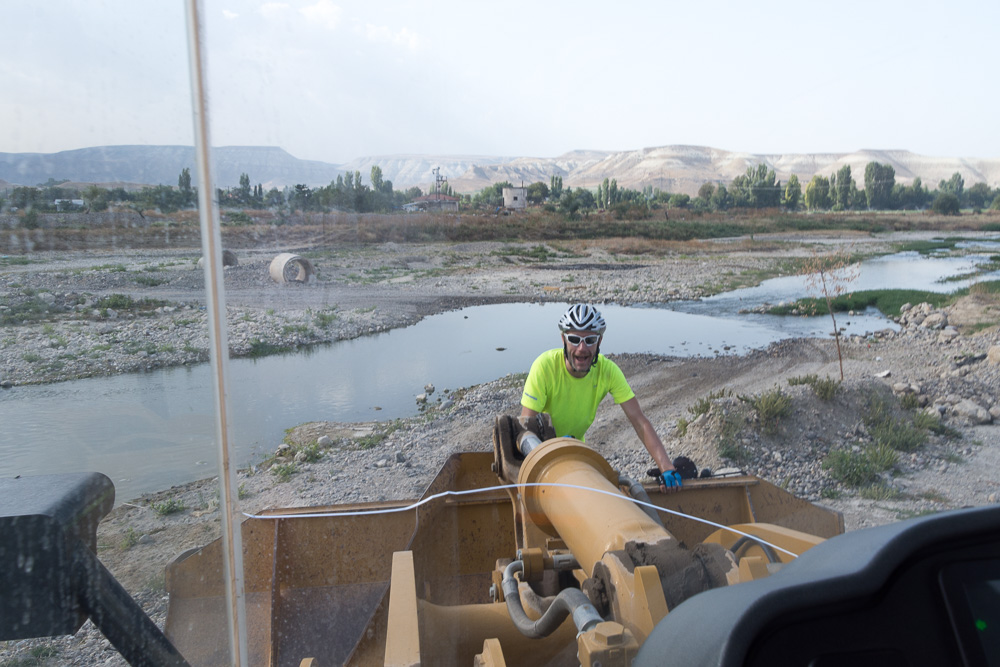 The bridge was down so we couldn't cross the river...so hitched a lift in a JCB!