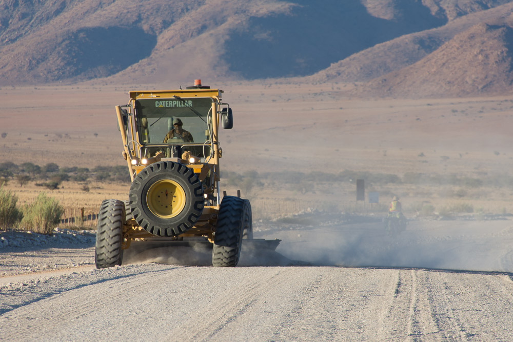 Emily's lost in the dust of the grading machine. Seriously, a graded road makes all the difference!